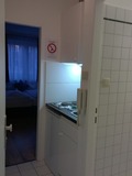 Seating area and bed in the triple bedroom apartment